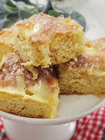 German yeast cake, called Zuckerkuchen, on white cake stand.